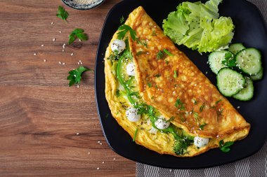 Omelette with mozzarella cheese and avocado. Ketogenic, keto diet breakfast. Top view, copy space