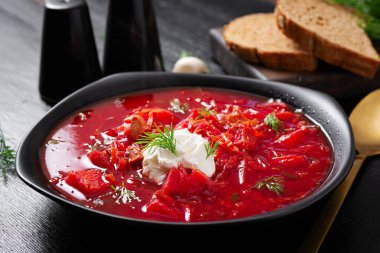 Traditional Ukrainian borscht. Bowl of red beetroot soup borsch with white cream. Beet root delicious soup. Ukrainian food.