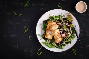 Sos ve pancar salatası içinde fırında tofu şişleri, sebze yoğurt soslu roka. Sağlıklı vejetaryen gıda konsepti. Sağlıklı yiyecekler. Üst manzara, düz uzanma