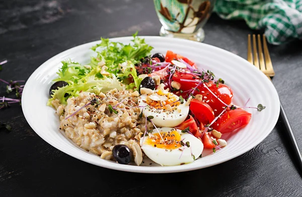ゆで卵 チェリートマト オリーブ ナッツ マイクログリーンの朝食オートミール粥 健康的なバランスの取れた食品 — ストック写真