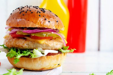 Tavuk burger. Tavuklu sandviç, domates, peynir, salatalık turşusu ve marul. Çizburger..