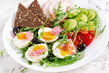 Healthy breakfast. Boiled egg, chicken ham, bread and fresh salad. Keto breakfast.