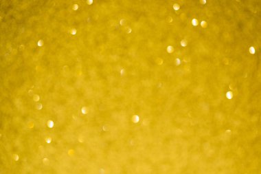 Parlak arkaplan, yansımalarla dolu parıltılı doku ve sarı renkli süslemeler.