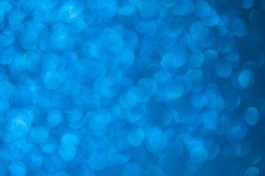 Parlak arkaplan, yansımalarla dolu parıltılı doku ve mavi renkte süslemeler..