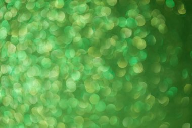 Parlak arkaplan, yansımalarla dolu parıltılı doku ve yeşil renkli süslemeler..