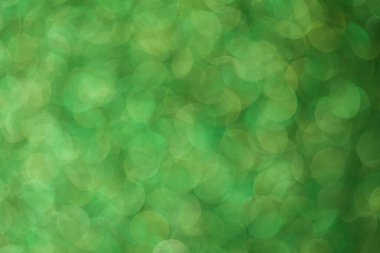 Parlak arkaplan, yansımalarla dolu parıltılı doku ve yeşil renkli süslemeler..