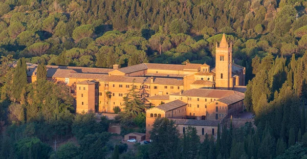 stock image Sunrise view of the Abbey of Monte Oliveto Maggiore, a large Benedictine monastery in the Italian region of Tuscany