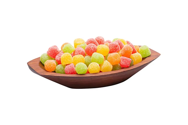 Gum bullets also called jelly beans. Sweets typical of the Junina Party in Brazil. Traditional Brazilian food in wooden bowl, sweet festa junina. White background for clipping. Without shadow.