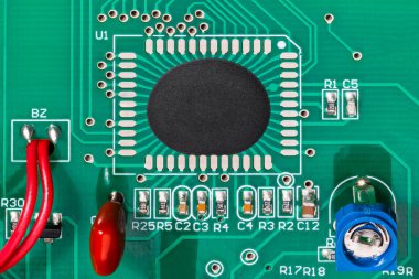 Chip on board assembly of integrated circuit on green texture PCB with red wires. Closeup a directly bonded microchip in epoxy drop and electronic components as potentiometer, resistors or capacitors. clipart