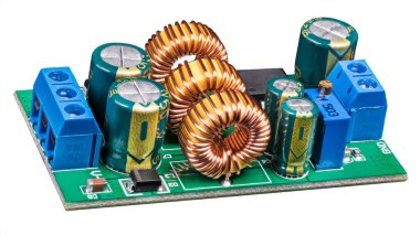 Electronic components on circuit board of power supply converter isolated on a white background. Close-up of toroidal coils, electrolytic capacitors or resistor trimmer and screw terminals on green PCB. clipart