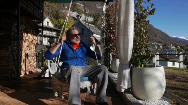 Mature Man Sitting Swing Chair — Vídeo de Stock
