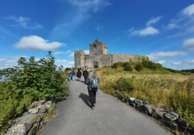 GALWAY, IRELAND - JULY 28, 2024: People visit the Dunguaire Castle, 16th-century tower house in County Galway near Kinvarra clipart