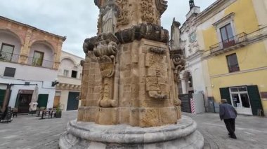 NARDO, İTALYA - 13 Nisan 2025: Salandra Meydanı 'nın ortasındaki lekesiz çan kulesinin altındaki insanlar