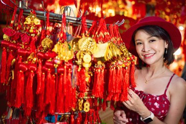 thai woman posing with good luck charms at yaowarat china town in bangkok thailand during chinese new year