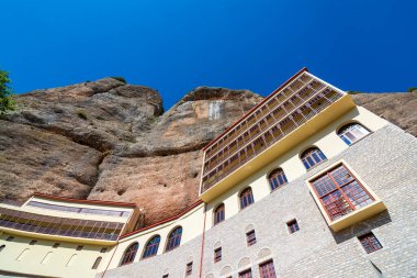 View of the Monastery Of Mega Spilaio in Kalavryta, Greece. The monastery is located in a large cave on a sheer cliff. Formerly known as the Monastery of the Dormition of the Theotokos. clipart