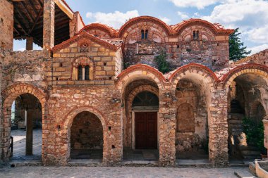 The intricate facade of Saint Demetrius Church (Mitropolis of Mystras), featuring stunning Byzantine architecture and historic arches. clipart