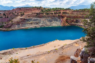 Yunanistan 'ın Evia kentindeki kayalık yamaçlar ve seyrek yeşilliklerle çevrili Triadas Gölü' ndeki turkuaz suların canlı bir görüntüsü.