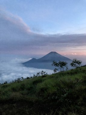 The view from the summit of Mount Sindoro, with Mount Sumbing next to it in the mornin