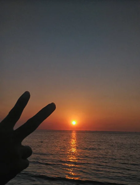 Peace and love symbol with sunset/sunrise on the ocean. Seen from a cruis