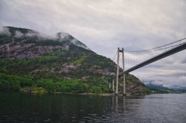 Norway Coast Fjord view from boat on ocean. Mountains, forests, waterfalls and small towns. Scandinavia, Norway clipart