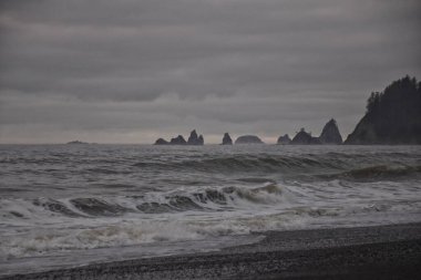 Rialto Beach beach and ocean island views at dusk in Olympic National Park, Washington State, USA.  clipart