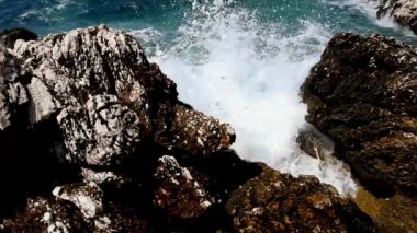 Sea waves crashing against rocks on the ocean shore