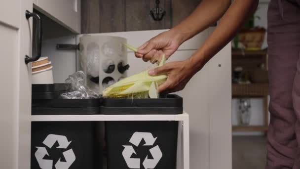 Woman Peels Corn Throwing Outer Leaves Trash Bin Standing Kitchen — Video Stock