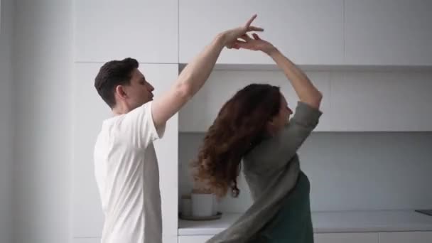 Married Couple Love Dances Vigorously Bright Kitchen Hugs Kisses Woman — Stockvideo