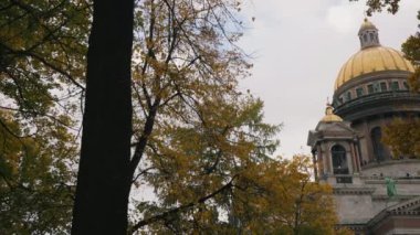 Horizontal panorama of St. Isaacs Cathedral from Alexander Park through autumn trees with yellow leaves. The historical center of the city of st. petersburg.
