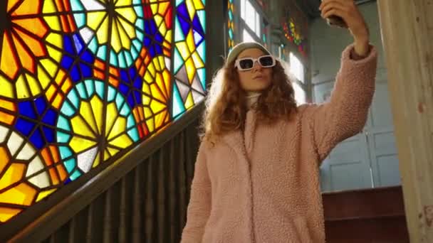 Curly Blogger Woman Takes Pictures Herself Phone Background Stained Glass — Stock Video