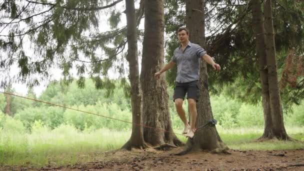 Sportovec Kráčí Podél Natažené Čáry Mezi Stromy Parku Udržuje Rovnováhu — Stock video