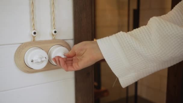 Woman White Robe Turns Light Bathroom Enters Closing Door Close — Stock Video