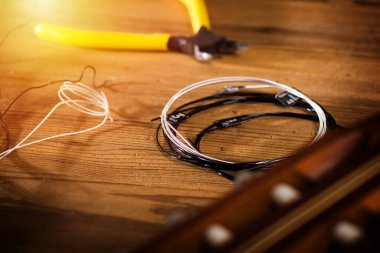 Restring classical guitar concept. Closeup at the new strings.