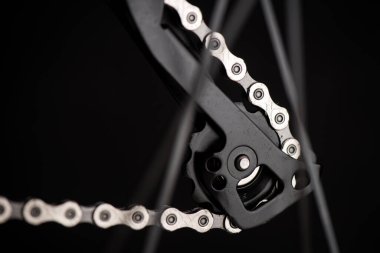 Closeup the chain on the moutain bike over black background.