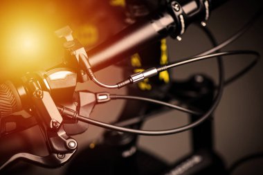 Closeup the cables on the moutain bike in low light.