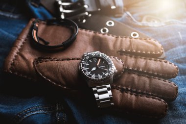 Men's dressing concept. Men's accessories. Close up at luxury men watch with black dial and stainless steel bracelet.