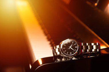 closeup luxury men watch on the piano.