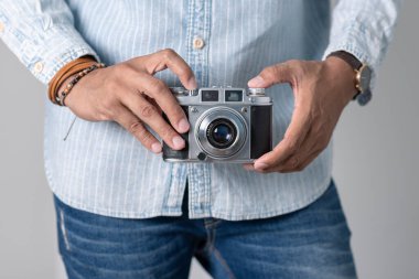 Old film camera in man's hand. Photography and hobby concept. 