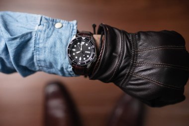 The man looking the time on his watch.