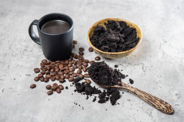closeup used coffee grounds in wooden spoon