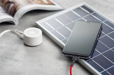 Akıllı telefonu güneş enerjisiyle şarj etmek. Yeşil enerji kavramı.