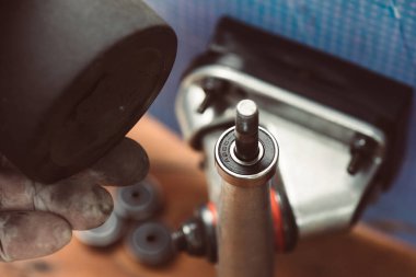 Skateboard and surfskate maintenance concept. Selective focus on the bearing. clipart