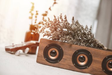 Rahatlatıcı konsept, müzik için portatif hoparlörü kapat ve masada kurumuş çiçeklerle bekle..