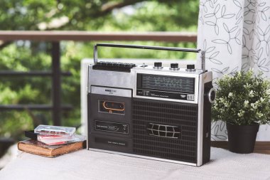 Oturma odasında kasetçalar olan klasik taşınabilir radyo. Müzik dinleme konsepti.