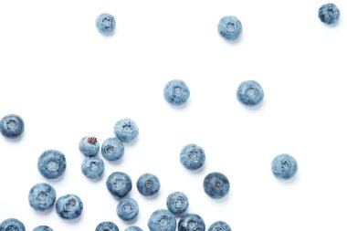 Fresh blueberries scattered on a white background.
