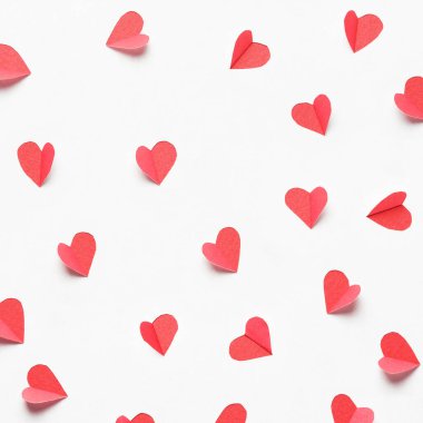 Hearts cut out from white paper. Festive background for valentine's day.