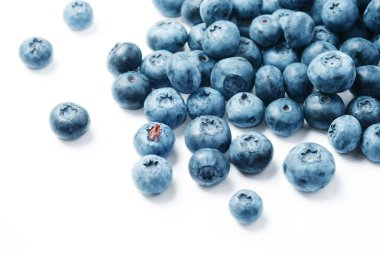 Fresh blueberries scattered on a white background.