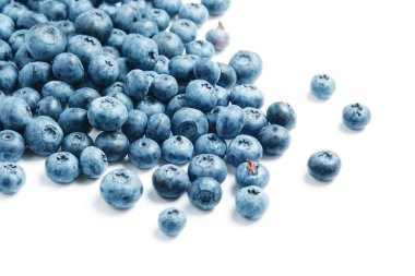 Fresh blueberries scattered on a white background.