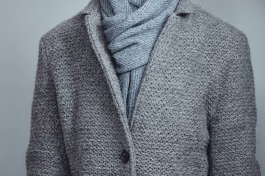 Gri örgü ceket ve mavi eşarp yakın plan. Kış, sonbahar sıcak yün giysiler.