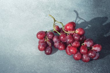 Güneş Işığı Kırmızı Üzüm Kümesi Dokulu Gri Yüzeye Gölge Döküyor